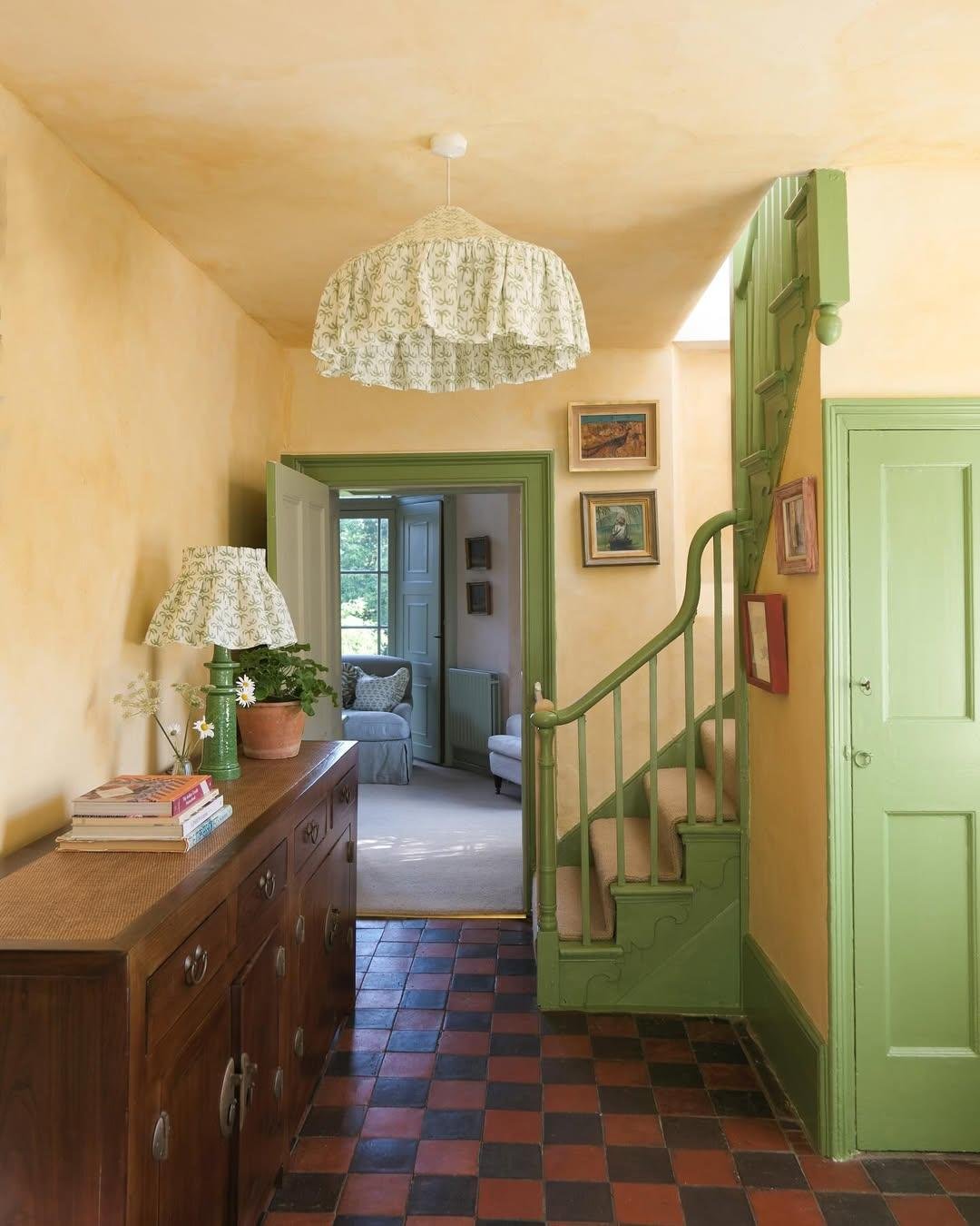 Painted woodwork against the lime wash wall works so well in this hall against the checkerboard